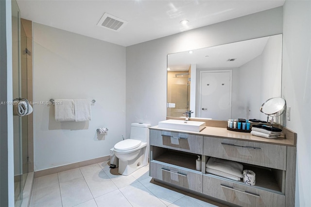 bathroom featuring tile patterned flooring, an enclosed shower, vanity, and toilet