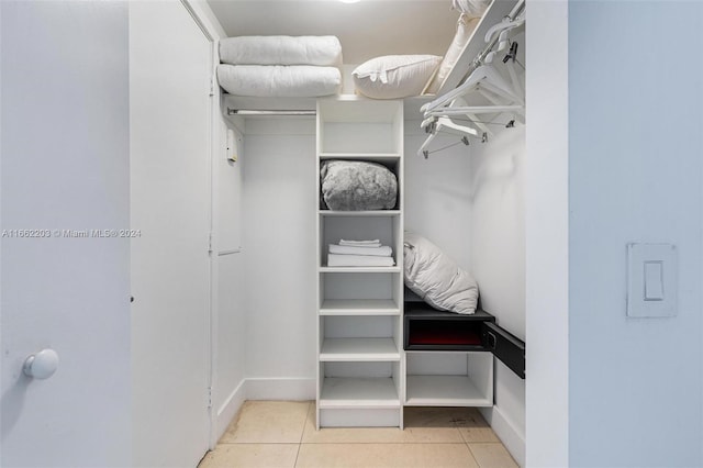 walk in closet with tile patterned floors