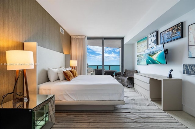 bedroom featuring tile patterned flooring, visible vents, and expansive windows