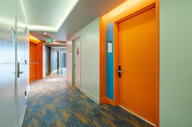 corridor with wood finished floors and baseboards
