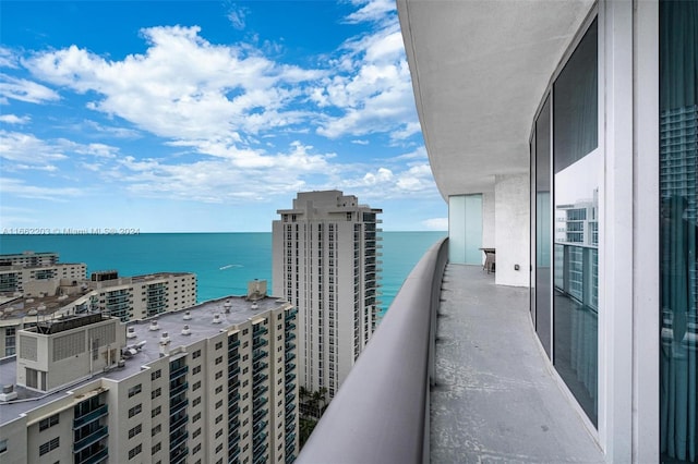 balcony with a water view and a city view