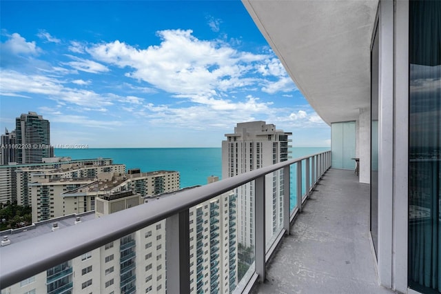 balcony featuring a city view and a water view