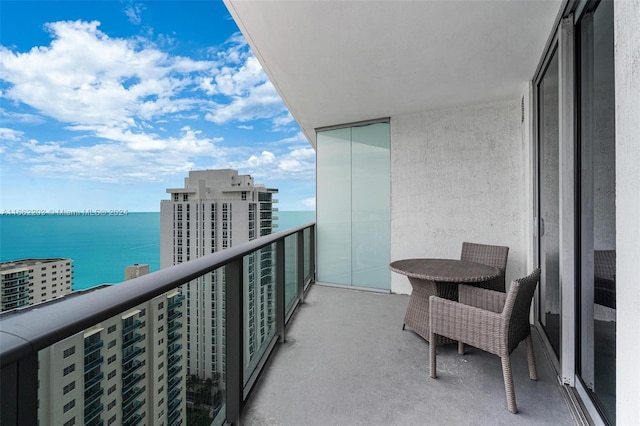 balcony featuring a city view and a water view