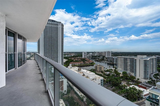 balcony featuring a view of city and a water view