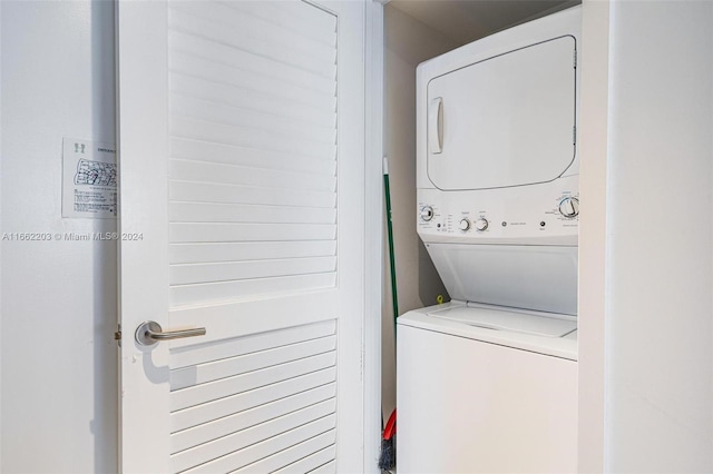 clothes washing area with stacked washer and dryer