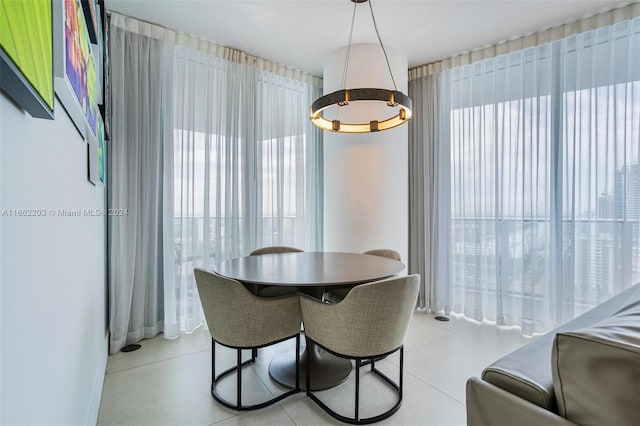 dining room featuring a notable chandelier and light tile patterned flooring