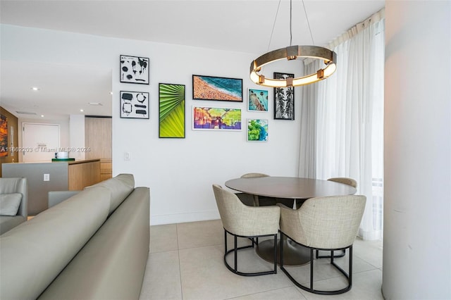 dining room with light tile patterned floors, recessed lighting, and baseboards