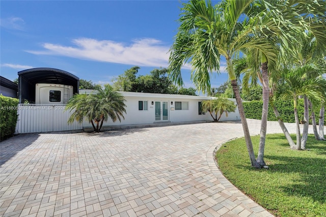 view of front of property featuring a front lawn and french doors