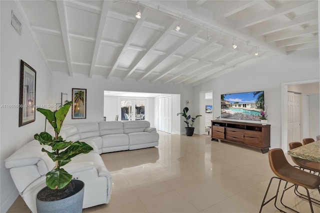 living room featuring french doors, light tile patterned flooring, lofted ceiling with beams, and track lighting