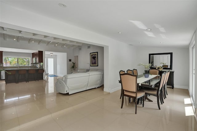 dining room featuring lofted ceiling and rail lighting