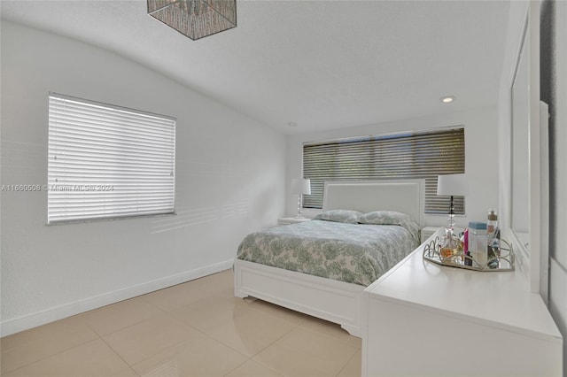 tiled bedroom with lofted ceiling