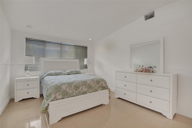 tiled bedroom featuring lofted ceiling