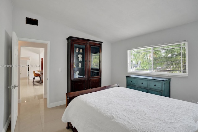 tiled bedroom with lofted ceiling