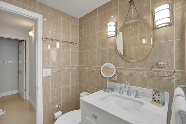 bathroom featuring tile walls and vanity