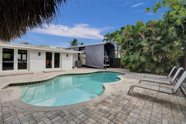 view of pool with central AC and a patio area