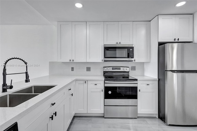 kitchen featuring sink, stainless steel appliances, and white cabinets