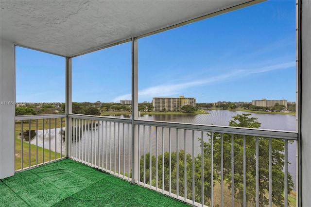 unfurnished sunroom featuring a water view