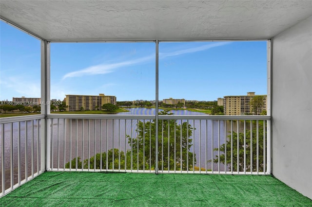 unfurnished sunroom featuring a water view