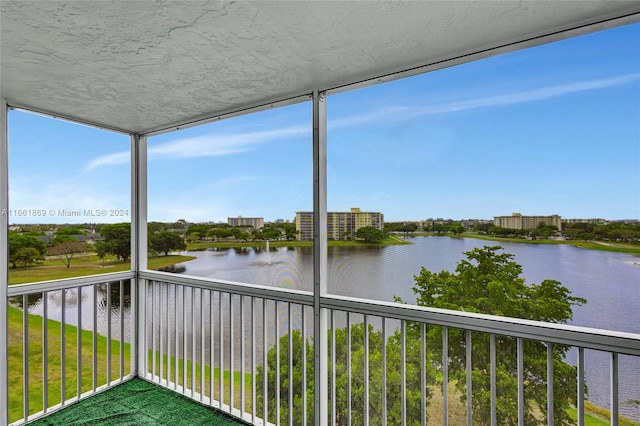 unfurnished sunroom with a water view