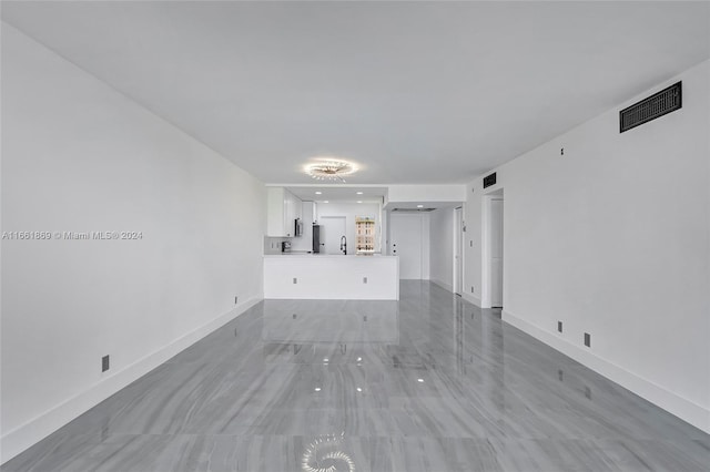 unfurnished living room with sink