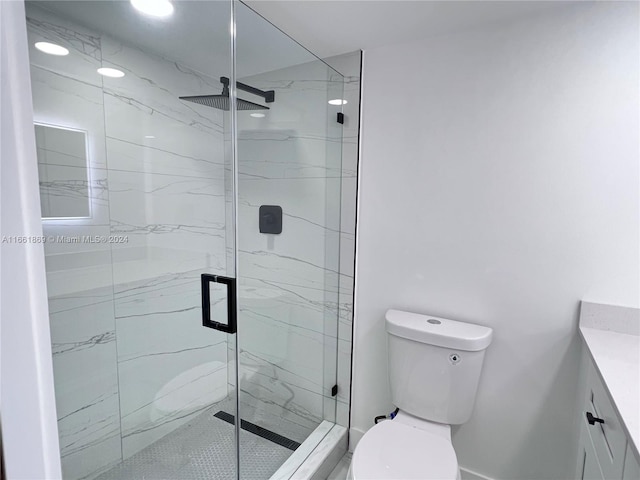 bathroom featuring walk in shower, vanity, and toilet