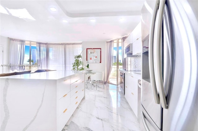 kitchen featuring appliances with stainless steel finishes and white cabinetry