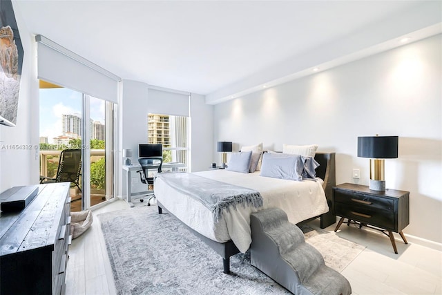 bedroom featuring light wood-type flooring and access to exterior