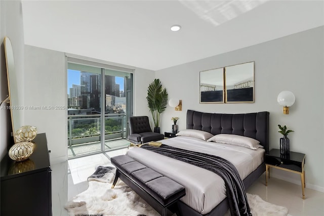 tiled bedroom featuring a city view, baseboards, and access to outside