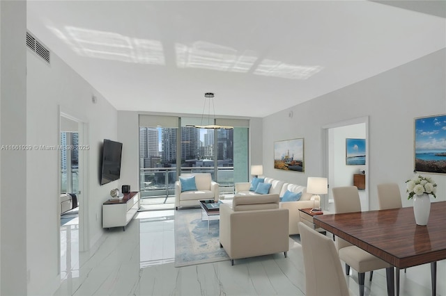 living room with visible vents, marble finish floor, and expansive windows