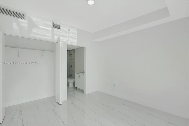 unfurnished bedroom with visible vents, marble finish floor, ensuite bath, and baseboards