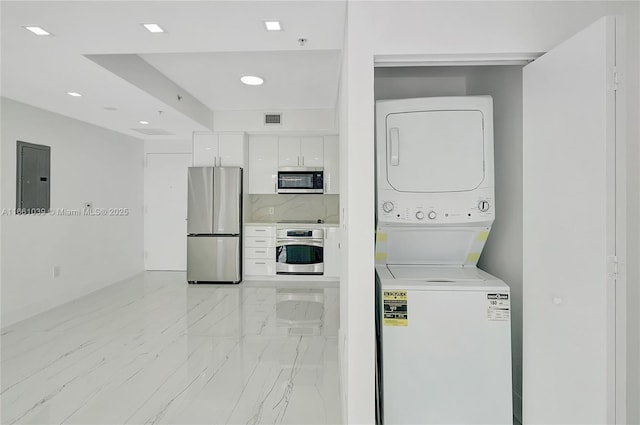 laundry room with visible vents, stacked washing maching and dryer, laundry area, electric panel, and marble finish floor