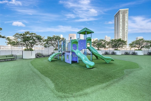 communal playground featuring fence