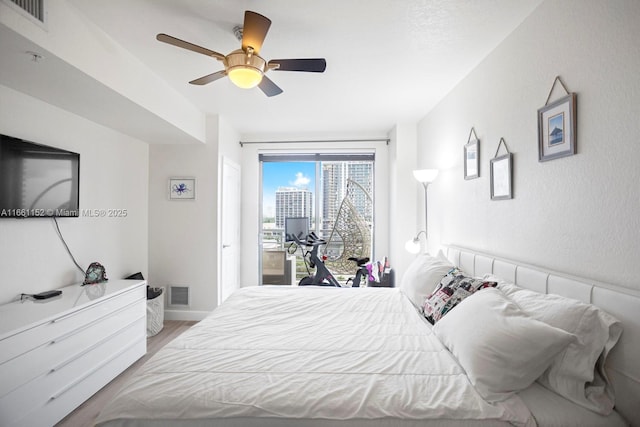 bedroom with access to outside, ceiling fan, and light hardwood / wood-style floors