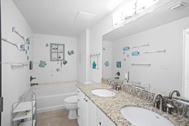 bathroom featuring tile patterned flooring, vanity, a tub to relax in, and toilet