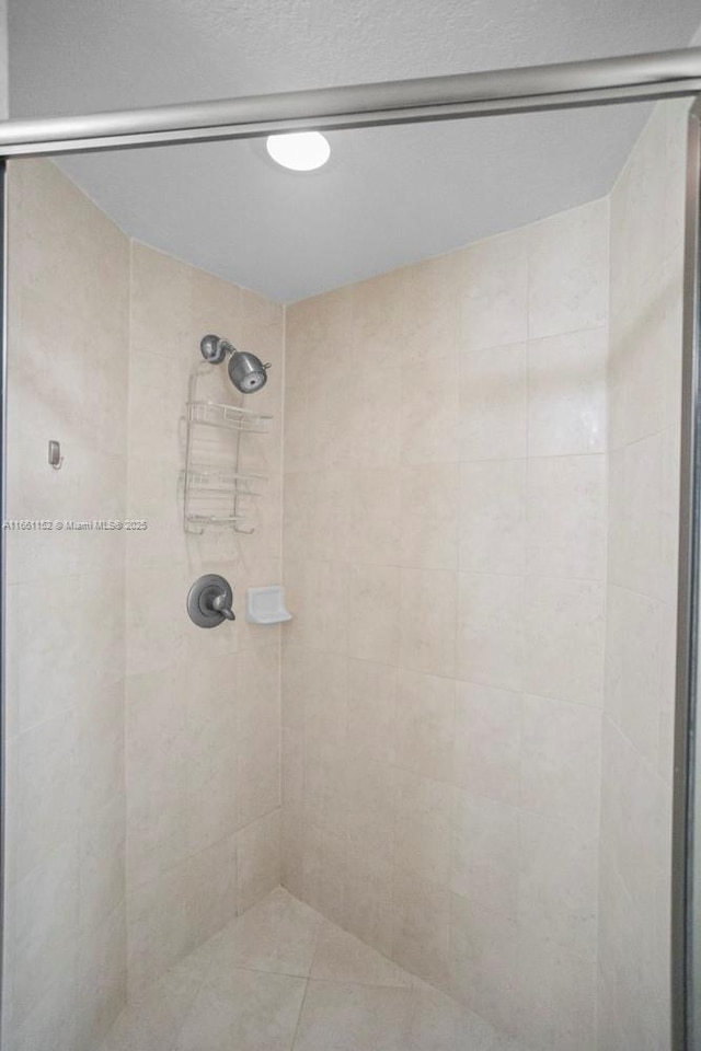 bathroom with tiled shower