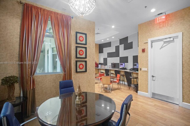 dining room featuring hardwood / wood-style floors and a notable chandelier