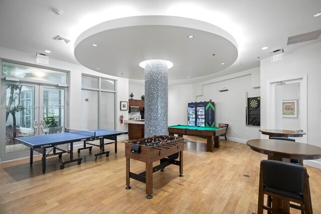 game room featuring light hardwood / wood-style floors, pool table, and french doors