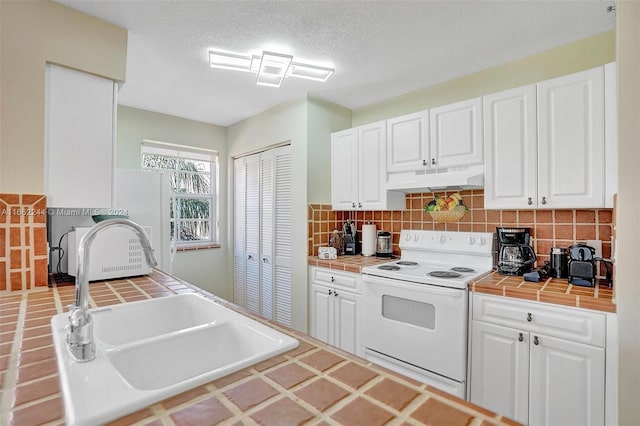 kitchen with sink, white cabinetry, tile countertops, electric stove, and decorative backsplash