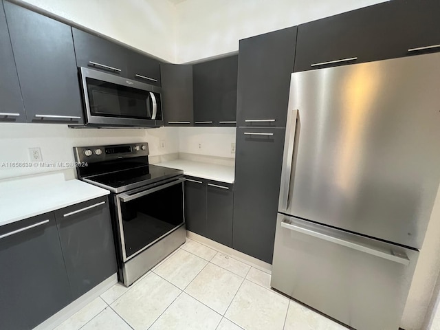 kitchen with stainless steel appliances and light tile patterned floors