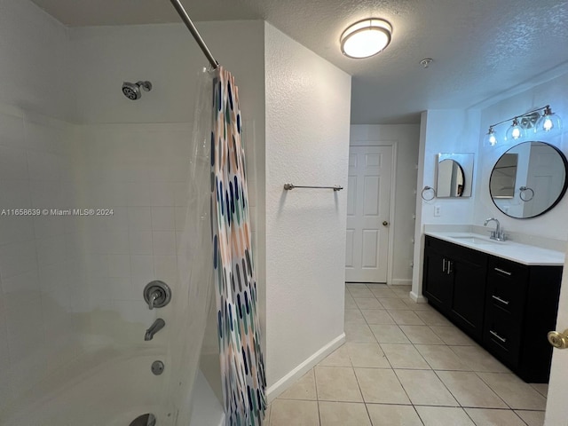 bathroom with a textured ceiling, shower / tub combo, vanity, and tile patterned floors