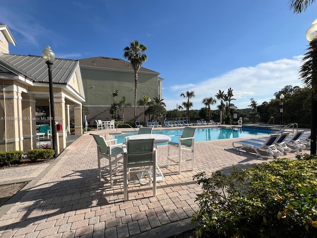 view of swimming pool featuring a patio