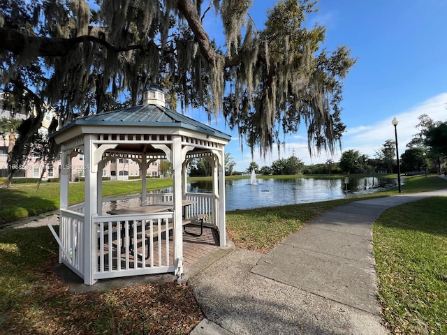 surrounding community with a gazebo, a water view, and a yard