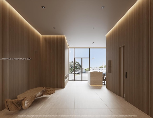 hallway featuring wood walls