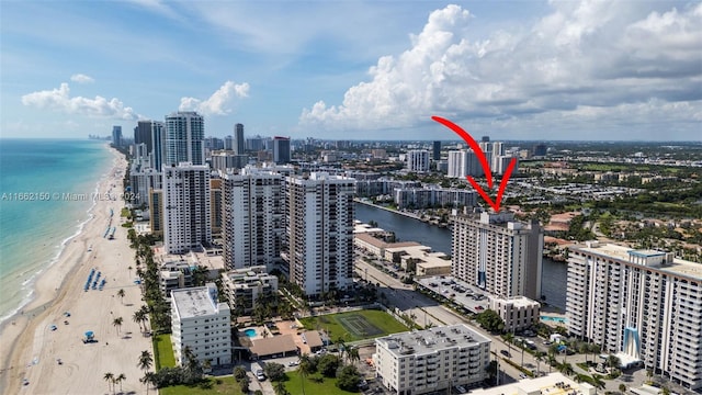 birds eye view of property with a beach view and a water view