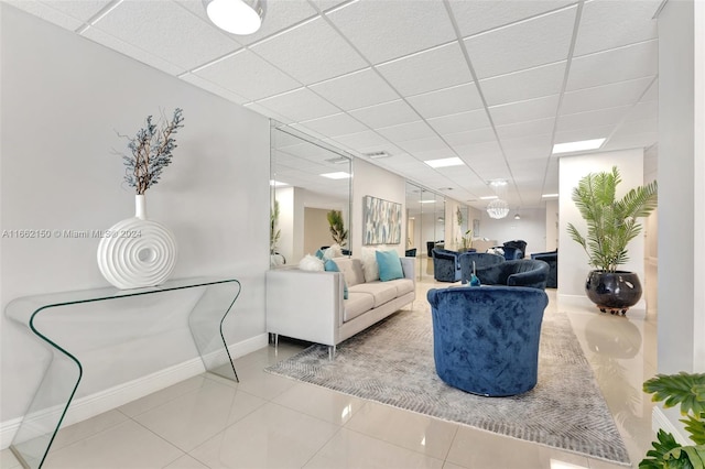 tiled living room with a drop ceiling