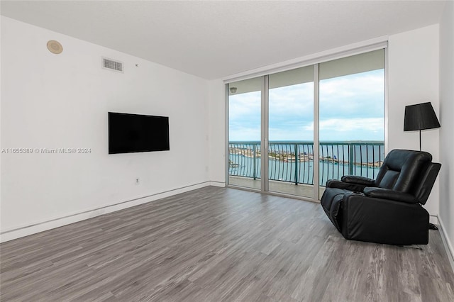 living room with floor to ceiling windows and wood-type flooring