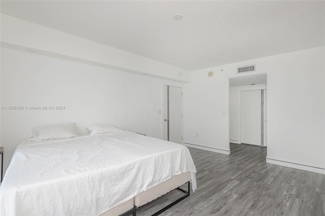 bedroom with wood-type flooring