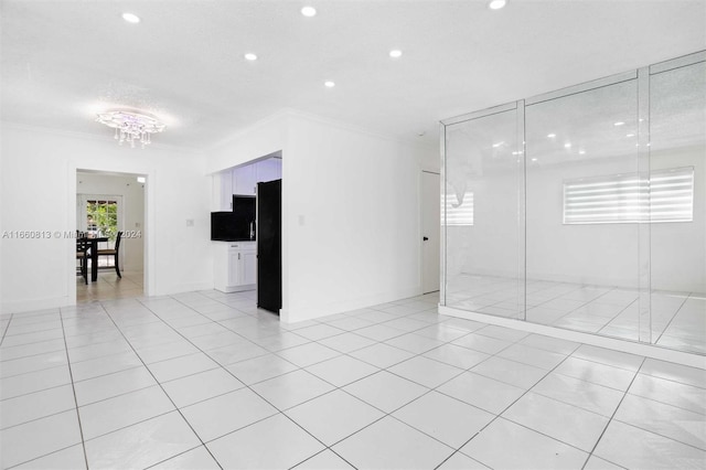 tiled spare room with ornamental molding