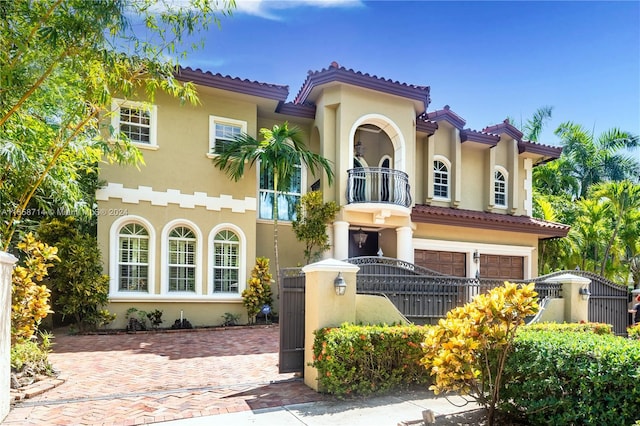 mediterranean / spanish house with a balcony and a garage