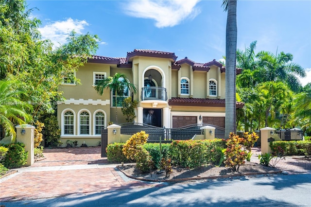 mediterranean / spanish house featuring a balcony and a garage